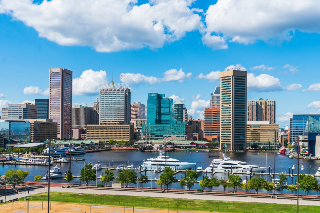 Baltimore's Inner Harbor, with waterfront yachts and turquoise glass towers of the downtown skyline