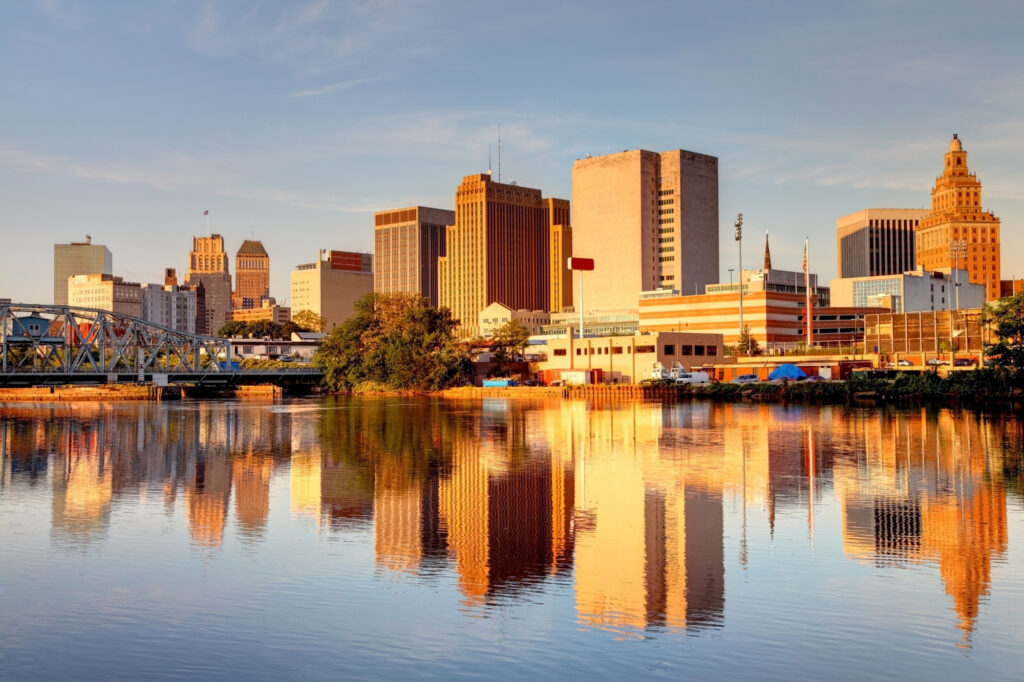 Downtown skyline of Newark, New Jersey, reflecting in the Passaic River during golden hour