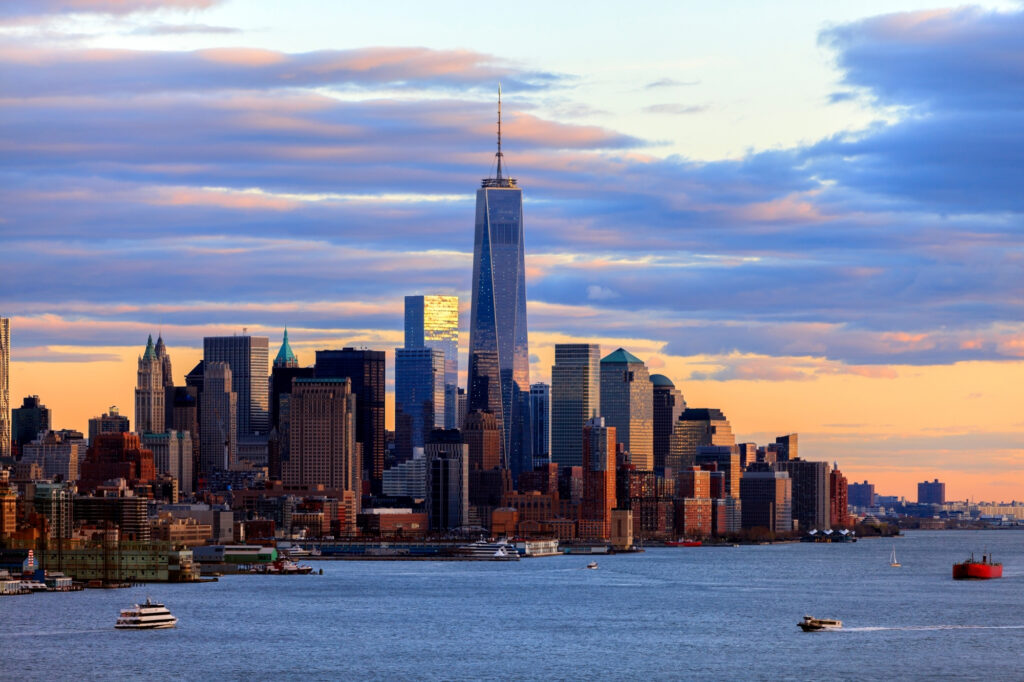One World Trade Center towering above the Lower Manhattan skyline in New York City at sunset