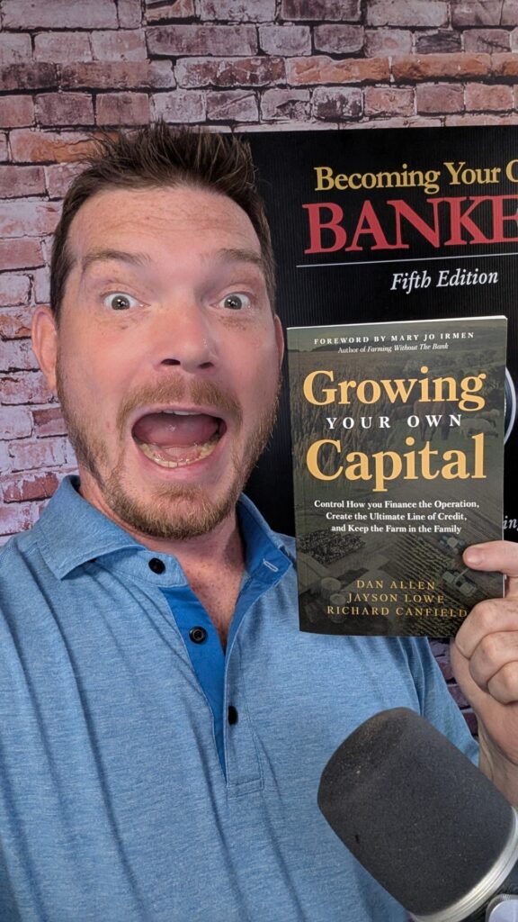Richard Canfield holding the book Growing Your Own Capital, which he co-authored about Infinite Banking and financial control.